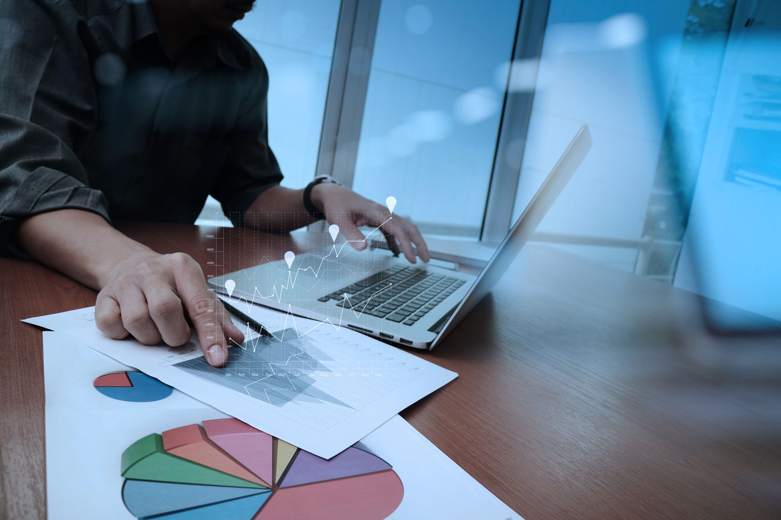 business documents on office table with smart phone and digital two computer desktop on a table